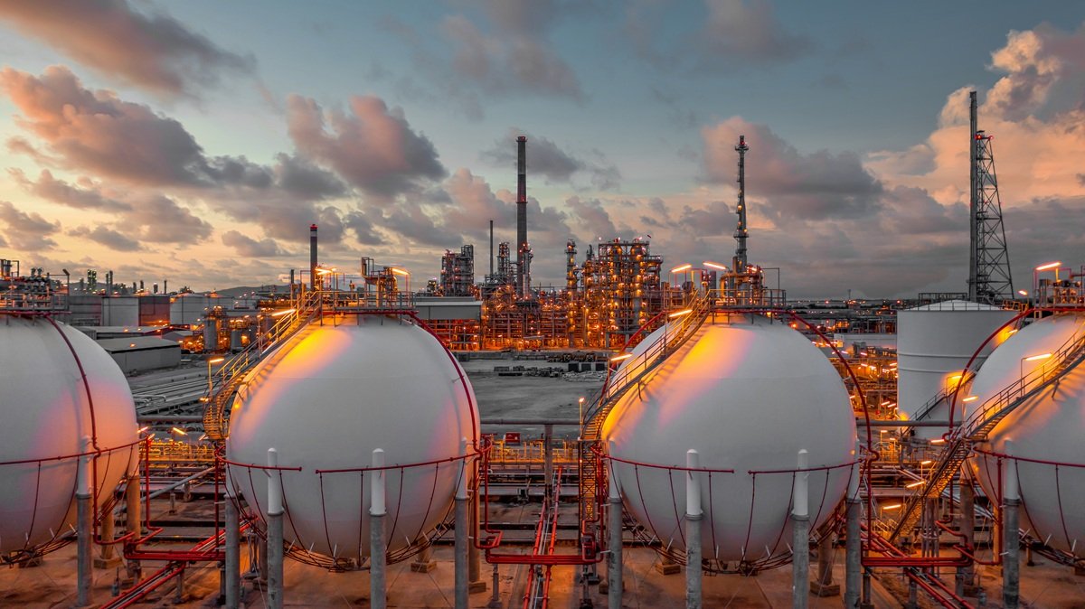 Spherical gas storage tanks at a U.S. oil and gas refinery glowing at sunset