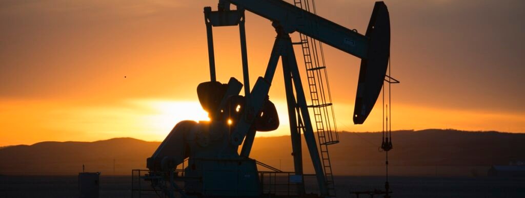 Oil pump jack silhouetted at sunset, symbolizing steady long-term U.S. energy demand