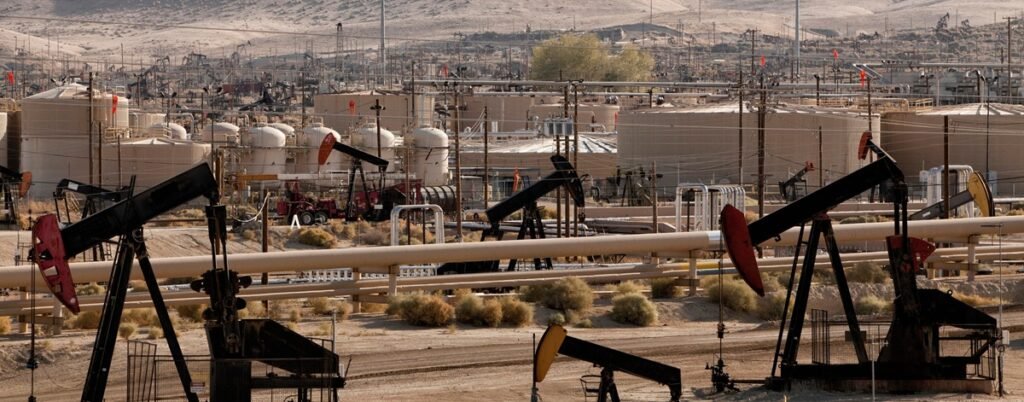 U.S. oil and gas production Active U.S. oilfield with multiple pump jacks and storage tanks under a daytime sky