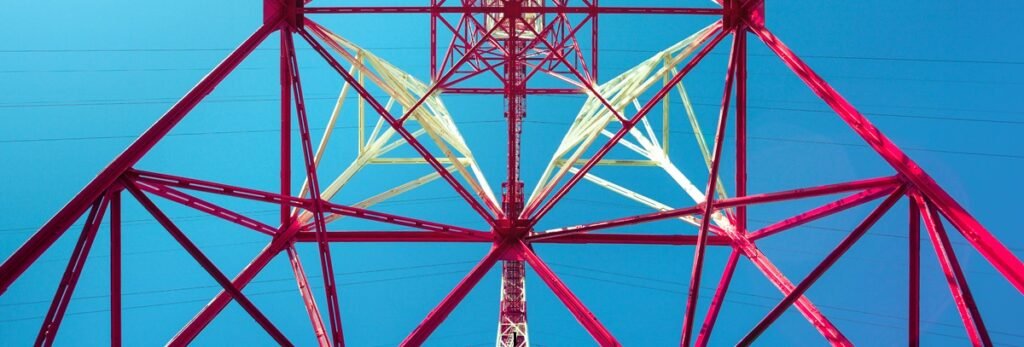 Oil well drilling rig Looking up the red steel framework of an onshore oil drilling rig derrick
